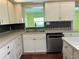 Kitchen area complete with stainless steel dishwasher, sink and window at 112 10Th St, St Cloud, FL 34769