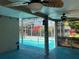 A covered patio with ceiling fans leads to the screened-in pool area at 112 10Th St, St Cloud, FL 34769