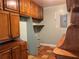 Tons of wooden cabinet space with tile flooring is ready to be stocked in this well-lit area at 112 10Th St, St Cloud, FL 34769