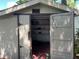 Backyard storage shed with barn doors, shelving, and room to organize at 112 10Th St, St Cloud, FL 34769