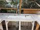 Inside greenhouse with an outdoor sink featuring tile countertop and stainless steel faucet with views to the backyard at 112 10Th St, St Cloud, FL 34769