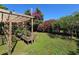 This backyard has a beautiful garden setup including a pergola and elevated garden beds at 112 10Th St, St Cloud, FL 34769