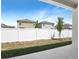 View of the backyard featuring a white fence and newly planted trees at 2007 Stetson Ave, Eagle Lake, FL 33839