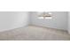 Light and airy bedroom with plush neutral carpeting and a view from a window at 2007 Stetson Ave, Eagle Lake, FL 33839