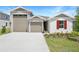Beautiful single-Gathering home featuring a two-car garage, manicured lawn, and neutral stucco at 2007 Stetson Ave, Eagle Lake, FL 33839