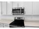 Close up of a modern kitchen featuring stainless steel microwave and electric stove at 2007 Stetson Ave, Eagle Lake, FL 33839