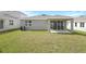 Exterior of home featuring a covered patio and a well-maintained lawn at 1651 Sugarbelle Cir, Mascotte, FL 34753
