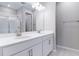 Bright bathroom featuring a double vanity with modern fixtures and a glass-enclosed shower at 1651 Sugarbelle Cir, Mascotte, FL 34753