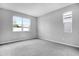 Spacious bedroom with neutral carpet and ample natural light from two large windows at 1651 Sugarbelle Cir, Mascotte, FL 34753
