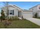 Beautiful single-Gathering home with a two-car garage, complemented by landscaping at 1651 Sugarbelle Cir, Mascotte, FL 34753