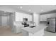 Modern kitchen with white cabinets, stainless steel appliances, and a center island at 1651 Sugarbelle Cir, Mascotte, FL 34753