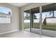 Bright living room with a sliding glass door leading to a patio and backyard at 1651 Sugarbelle Cir, Mascotte, FL 34753