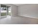 Open living room with tile floors and sliding glass doors leading to outdoor space at 1651 Sugarbelle Cir, Mascotte, FL 34753