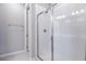 Modern bathroom with a shower featuring white tiled walls and a glass enclosure at 1651 Sugarbelle Cir, Mascotte, FL 34753