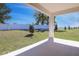 Covered patio overlooks a spacious backyard with green grass and a white privacy fence at 1655 Sugarbelle Cir, Mascotte, FL 34753