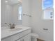 A bathroom with a white vanity, neutral walls, a window with bright natural light, and modern fixtures at 1655 Sugarbelle Cir, Mascotte, FL 34753