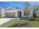 Charming single-story home featuring a two-car garage and fresh landscaping in a well maintained front yard at 1655 Sugarbelle Cir, Mascotte, FL 34753