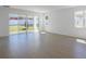 Living room featuring tile flooring, sliding glass doors to the backyard, and neutral walls at 1655 Sugarbelle Cir, Mascotte, FL 34753
