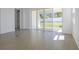 Living room with tile flooring and sliding glass doors leading to the outdoor space and backyard at 1655 Sugarbelle Cir, Mascotte, FL 34753