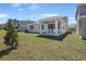 Beautiful backyard with a covered patio and lush green lawn, perfect for outdoor living at 1667 Sugarbelle Cir, Mascotte, FL 34753