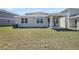 A spacious backyard with green grass and a covered patio, great for outdoor entertainment at 1667 Sugarbelle Cir, Mascotte, FL 34753