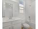 Clean, all-white bathroom with a shower-tub combination, a modern vanity and tile flooring at 1667 Sugarbelle Cir, Mascotte, FL 34753