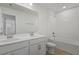 Bright bathroom features a double sink vanity and a shower-tub combination with tiled walls at 1667 Sugarbelle Cir, Mascotte, FL 34753
