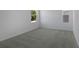 Empty bedroom with carpet flooring, natural light, and views from exterior windows at 1667 Sugarbelle Cir, Mascotte, FL 34753