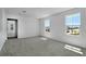 Bright bedroom with carpeted floors and natural light from the two large windows at 1667 Sugarbelle Cir, Mascotte, FL 34753