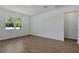 Spacious bedroom with wood-look tile flooring, a large window, and neutral paint at 1667 Sugarbelle Cir, Mascotte, FL 34753