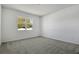 Neutral bedroom featuring carpeted floors, a window providing natural light, and ample open space at 1667 Sugarbelle Cir, Mascotte, FL 34753