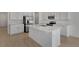 Modern kitchen featuring white cabinets, stainless steel appliances, and a large central island at 1667 Sugarbelle Cir, Mascotte, FL 34753