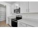 Close-up of the kitchen appliances and features including the microwave, oven, and white cabinets at 1667 Sugarbelle Cir, Mascotte, FL 34753