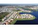 A picturesque aerial shot highlighting the home's lakeside location and lush green surroundings at 3960 Steer Beach Pl, Kissimmee, FL 34746
