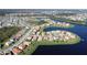 Stunning aerial view of a residential community with numerous homes nestled around picturesque lakes and waterways at 3960 Steer Beach Pl, Kissimmee, FL 34746