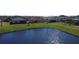 Scenic backyard view of homes bordering a serene pond, offering privacy and a connection with nature at 3960 Steer Beach Pl, Kissimmee, FL 34746