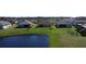 Tranquil backyard setting of several homes adjacent to a serene pond, offering a peaceful retreat at 3960 Steer Beach Pl, Kissimmee, FL 34746