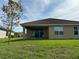 Backyard with a grassy lawn and covered patio, offering a relaxing outdoor space at 3960 Steer Beach Pl, Kissimmee, FL 34746