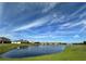 Scenic view of the backyard pond in a community on a sunny day at 3960 Steer Beach Pl, Kissimmee, FL 34746