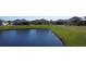 Picturesque backyard view of homes situated along a peaceful pond, creating a serene living environment at 3960 Steer Beach Pl, Kissimmee, FL 34746