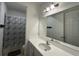 Bathroom with a single vanity and a tub with a blue and gray patterned shower curtain at 3960 Steer Beach Pl, Kissimmee, FL 34746