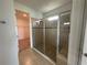Modern bathroom features a glass-enclosed shower with beige tiles and an adjacent walk-in closet at 3960 Steer Beach Pl, Kissimmee, FL 34746