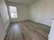 Bedroom with laminate flooring and a window allowing natural light at 3960 Steer Beach Pl, Kissimmee, FL 34746