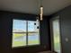 Dining area features a large window with a lake view and modern pendant lighting at 3960 Steer Beach Pl, Kissimmee, FL 34746