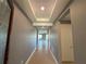 Inviting hallway with neutral walls and tile flooring leads to an open living space at 3960 Steer Beach Pl, Kissimmee, FL 34746