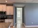 Bright kitchen features stainless appliances, granite countertops, and a doorway to another room at 3960 Steer Beach Pl, Kissimmee, FL 34746