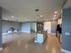 Open-concept living area with tile flooring, recessed lighting, and a kitchen island at 3960 Steer Beach Pl, Kissimmee, FL 34746