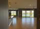 Open living space features tile flooring and a view of the lake from the patio at 3960 Steer Beach Pl, Kissimmee, FL 34746