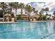 Resort style pool with lap lanes, fountains, and lounge area perfect for relaxation in a lush landscaped setting at 3960 Steer Beach Pl, Kissimmee, FL 34746