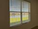 Water view as seen from a large window with white blinds at 3960 Steer Beach Pl, Kissimmee, FL 34746